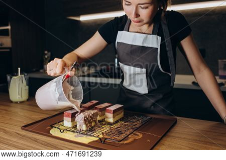 Beautiful Young Chef Decorating Delicious Dessert In Modern Kittchen