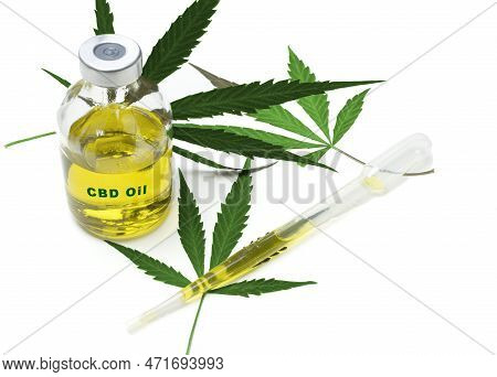 A Bottle With Medical Marijuana Oil With The Inscription Cbs Oil On A White Background With Some Dri