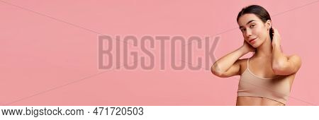 Young Beautiful Brunette Girl With Healthy Well-kept Skin Posing In Underwear Over Pink Studio Backg