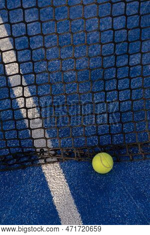 Paddle Tennis Ball In The Net Of A Blue Paddle Tennis Court.