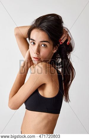 Portrait Of Beautiful Slim Young Brunette Girl With Natral Makeup Posing In Black Underwear Over Gre