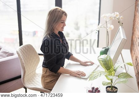 Successful Female Grapic Designer Watching Tutorial About Creative Ideas At Computer During Working 