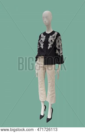 Full Length Image Of A Female Display Mannequin Wearing Black Long Sleeve Blouse With Embroidered Pa