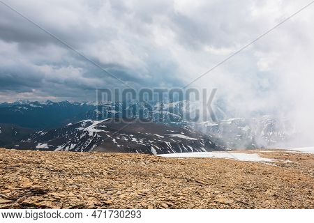 Awesome Top View Through Clouds To High Snowy Mountains. Scenic Landscape With Beautiful Snow Mounta