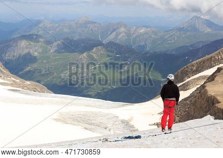 Mountaineer Standing On Glacier And Looking Towards Grossglockner High Alpine Road And Mountain Pano