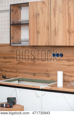 Installation And Installation Of A New Modern Kitchen In The House. Kitchen Cabinets In Various Stag