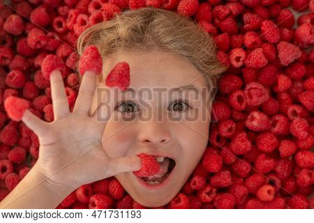 Excited Child Face With Raspberries. Summer Fruits. Fresh Raw Raspberry Near Kids Face. Raspberri Ma