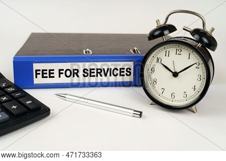 Business Concept. On A White Surface, An Alarm Clock Calculator And A Folder With The Inscription - 