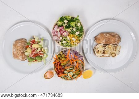 Vegetarian Salads And Sandwiches On Dining Table