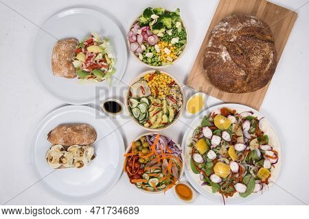 Vegetarian Salads And Sandwiches On Dining Table