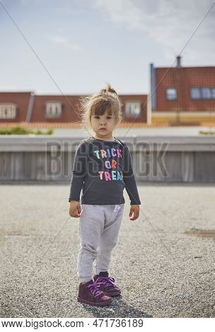 Sad Child Walking In The City In Denmark