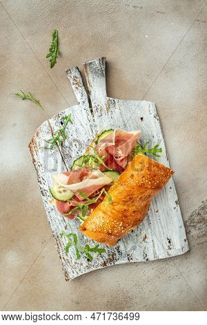 Ciabatta Sandwich With Jamon Ham Serrano Paleta Iberica, Arugula, Mediterranean Appetizer. Delicious