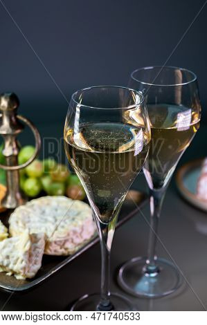 Glasses Of Sparkling White Wine Champagne Or Cava With Bubbles And French Soft Cheese On Background