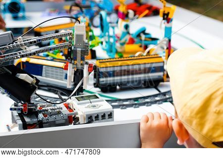 Robot Constructor. Defocus Little Boy Made Robots On Table. Train An Railway. Joyful Smart Whizzkid 