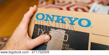 Frankfurt, Germany - Feb 23, 2023: Pov Male Hand Holding New Onkyo Cardboard For A Video Audio Home 
