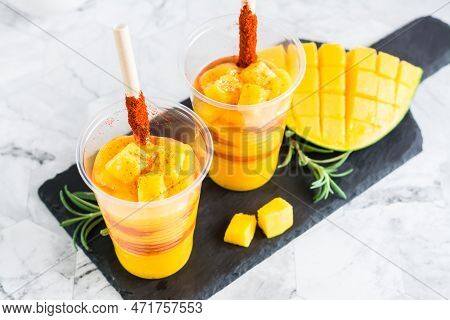 Mangonada Drink Made From Mango And Tajin Chili Powder In Plastic Glasses. Close-up. Mexican Dish