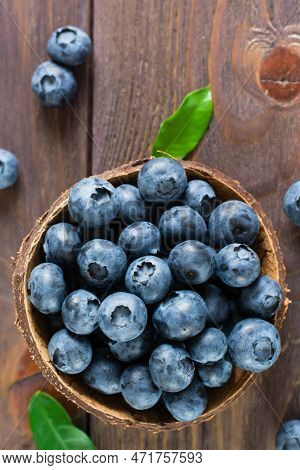 Bowl With Fresh Blueberries On A Wooden Table. Antioxidant Organic Healthy Food. Top And Vertical