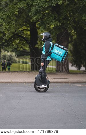 Riga, Latvia - June 8, 2022: Wolt Food Delivery Using Electric Unicycle