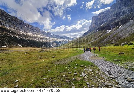 A Group Of Hikers In A Glacier Valley Known As Circo De Soaso In The Spanish Pyrenees