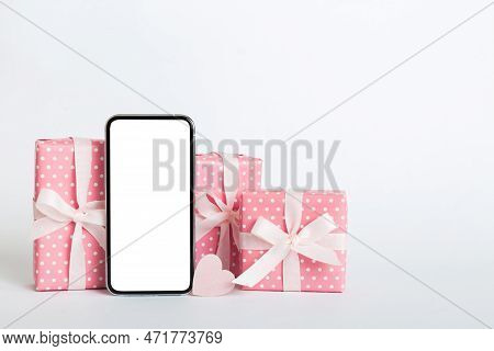 Mobile Phone With Blank Screen On Colored Background With Hearts, Calendar And Gift Box, Valentine D