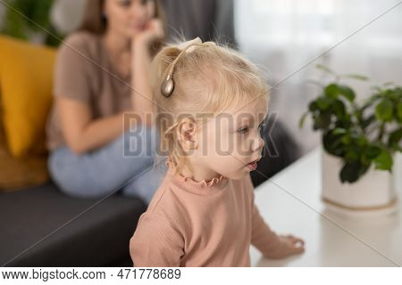 Cochlear Implant System. Installation Cochlear Implant On Child Girl Ear For Restores Hearing. Kid H