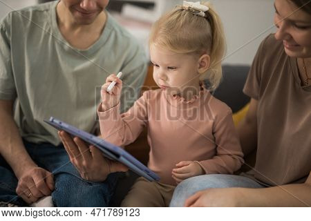 Deaf Child Girl With Cochlear Implant Studying To Hear Sounds And Have Fun With Mother And Father - 