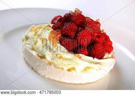 A Picture Of A Raspberry Pavlova Meringue Served With Caviar On A White Plate