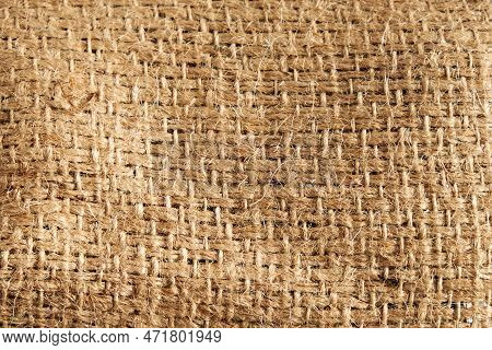 Detailed Natural Burlap Background. The Texture Of The Fabric Of A Brown Coarse Belt. Close-up