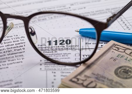 Income Tax With Instruction, Money And Glasses. Tax Payment And Filing Concept. 2022 Tax Return Form