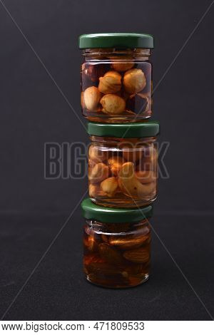 Glass Jars With Nuts In Honey. Delicious Sweets. Nuts In Honey. Sweet Nuts.