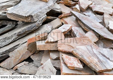 Heap Of Natural Brown Stone Fragments For Facing Walls And Laying Paths
