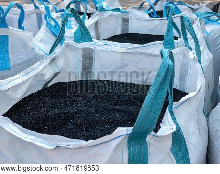 Black Polystyrene Granules In The Big Bags With Handles, Selective Focus. Construction And Repair Ma