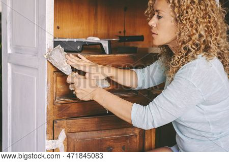 Sustainability And Recycling Work Et Home. Adult Young Woman Working On Old Furniture To Create New 