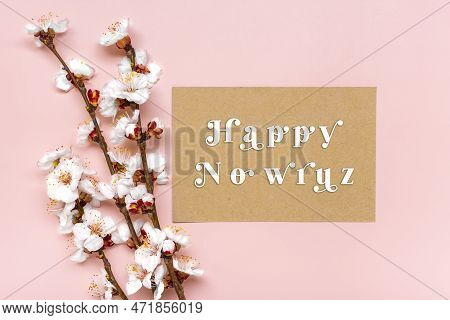 Sprigs Of The Apricot Tree With Flowers On Pink Background Text Happy Nowruz Holiday Concept Of Spri