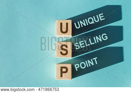 Usp Text On Wooden Blocks, Financial Business Concept, Blue Background. Usp - Short For Unique Selli