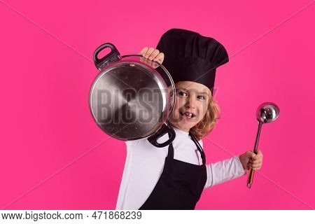 Fynny Kid Chef Cook With Cooking Pot And Ladle. Child In Cook Uniform. Chef Kid Isolated On Pink Bac