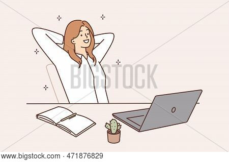 Smiling Woman Sitting At A Table With A Laptop Resting With Her Eyes Closed. Female Office Worker Or
