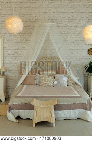 Beautifully Furnished Bedroom, Bed With Pillows And Baldachine In Light Tones