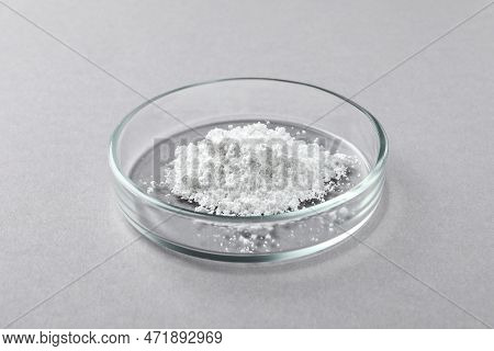 Petri Dish With Calcium Carbonate Powder On Light Grey Table, Closeup