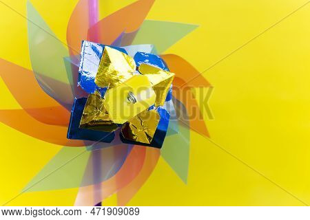 Wind Turbine Or Windmill Handmade Plastic Children's Colorful Toy Isolated On Yellow Background