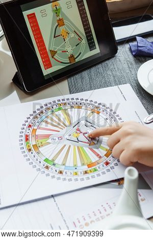 Tver, Russia - February 12, 2023: A Woman At The Table Is Studying A Rave Mandala By Human Design. R