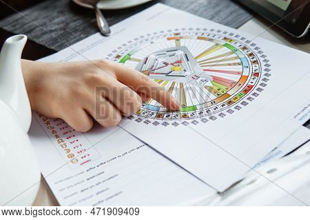 Tver, Russia - February 12, 2023: A Woman At The Table Is Studying A Rave Mandala By Human Design. R
