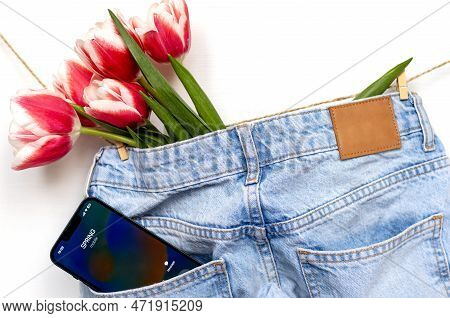 Tulips On Jeans And Spring Calling On Smartphone Kid Holding Flower