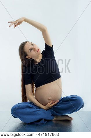 Pleasant Pregnant Woman Posing In Profile And Trying Yoga Young Happy Expectant Relaxing, Thinking A