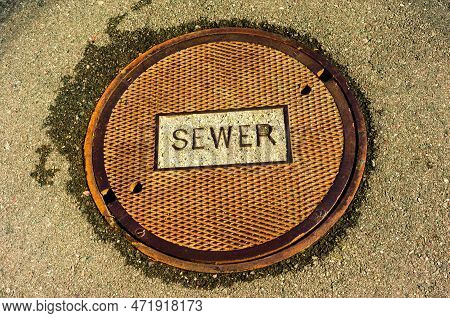 Colorful Utility Manhole Cover Convey An Aging Industrial Era, Made Of Sturdy Metal With A Patina Of