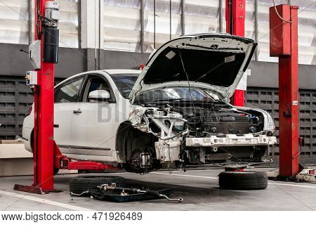 Closeup Car In Repair Station And Body Shop With Soft-focus And Over Light In The Background