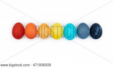Easter Multi-colored Eggs Laid Out In A Row Isolated On A White Background. Happy Easter Eggs Painte