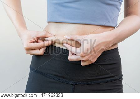 Obese, Obesity, Chubby Teen Asian Young Woman, Girl Hand In Holding Belly, Show Excess Fat Of Waist,
