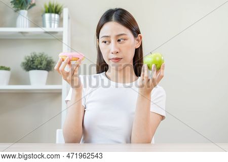 Diet, Dieting Asian Young Woman Or Girl Smile, Confused Choose, Choice Green Apple Or Pink Sweet Don