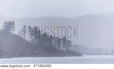Beautiful Calm Peaceful Winter Landscape Over Thirlmere In Lake District With Fog And Layers Of Tree